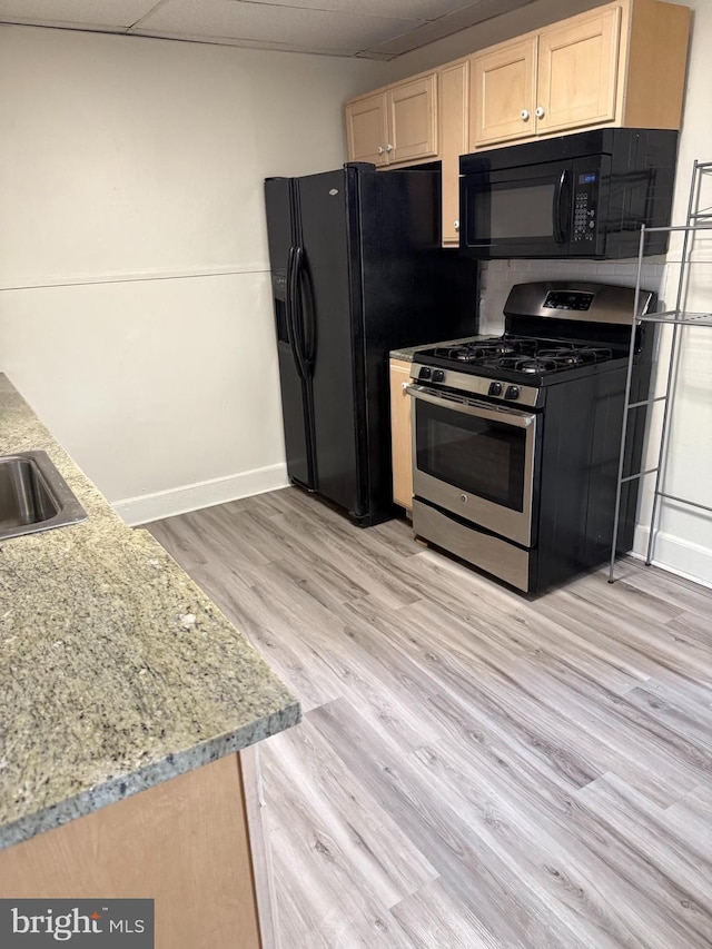 820 Cumberland St, Gloucester City, NJ 08030 - kitchen with black appliances, light brown cabinetry, light wood-style flooring, baseboards, and light stone counters