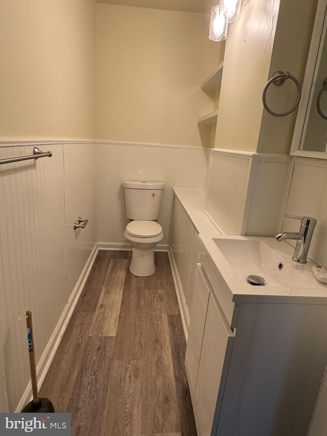820 Cumberland St, Gloucester City, NJ 08030 - bathroom with vanity, wood finished floors, toilet, a wainscoted wall, and a decorative wall