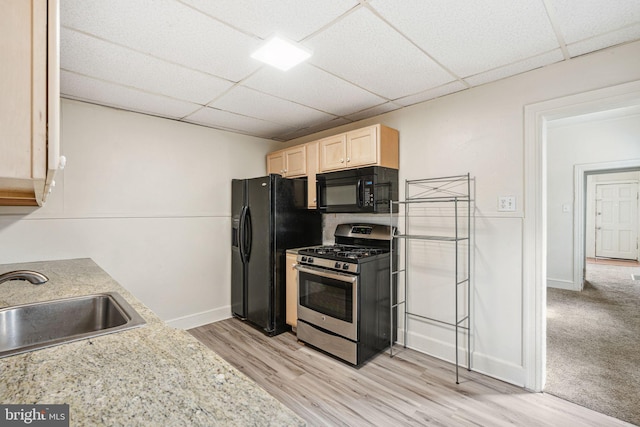 820 Cumberland St, Gloucester City, NJ 08030 - kitchen with black appliances, a sink, a drop ceiling, light brown cabinets, and light wood-style floors