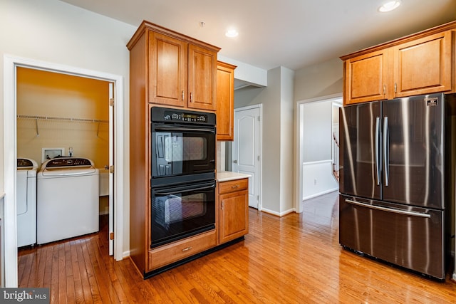256 Silverbell Ct, West Chester, PA 19380 - kitchen featuring freestanding refrigerator, washing machine and dryer, light wood finished floors, brown cabinetry, and baseboards