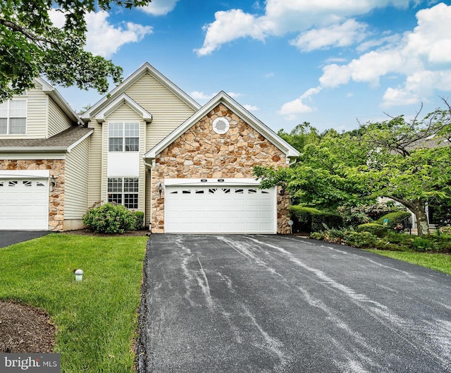 256 Silverbell Ct, West Chester, PA 19380 - view of front of home featuring stone siding, asphalt driveway, a garage, and a front lawn