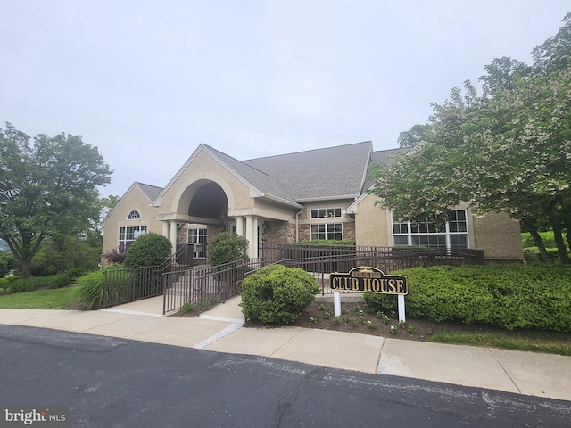 256 Silverbell Ct, West Chester, PA 19380 - view of front of property featuring stone siding, a fenced front yard, and stucco siding
