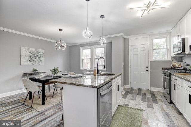 2503 W Forest Park Ave, Baltimore, MD 21215 - kitchen featuring stainless steel appliances, a sink, light wood-style floors, light stone counters, and white cabinetry