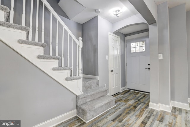 2503 W Forest Park Ave, Baltimore, MD 21215 - entrance foyer with baseboards, arched walkways, wood finished floors, and stairway