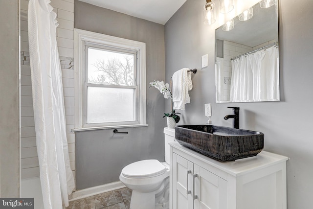 2503 W Forest Park Ave, Baltimore, MD 21215 - full bath featuring toilet, vanity, and baseboards
