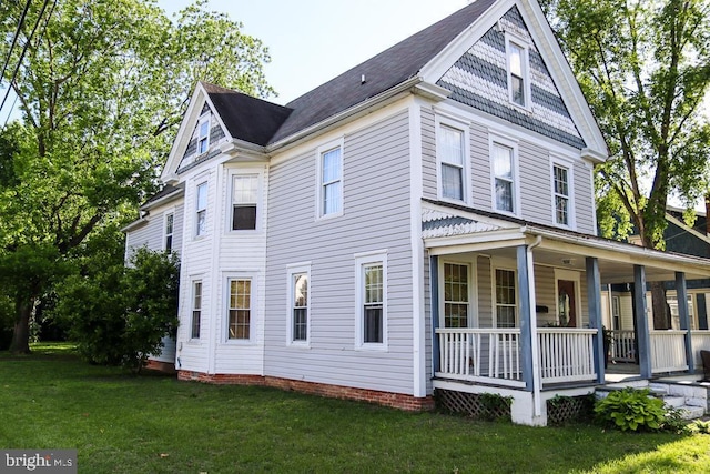 614 Market St, Denton, MD 21629 - view of side of home with a porch and a yard