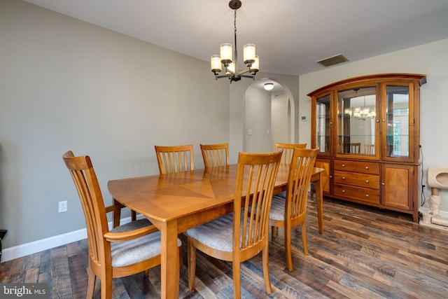 94 Eagle Ct, Woodstock, VA 22664 - dining room with a chandelier, dark wood-type flooring, arched walkways, and baseboards