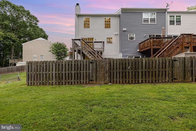 211 Westminster Ln Unit 119, Stafford, VA 22556 - back of property at dusk with stairs, a deck, and a chimney
