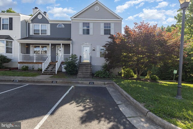 211 Westminster Ln Unit 119, Stafford, VA 22556 - multi unit property with uncovered parking, covered porch, a chimney, and a front lawn