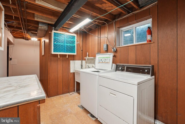 12834 Littleton St, Silver Spring, MD 20906 - laundry room with washing machine and dryer, wood walls, and light floors