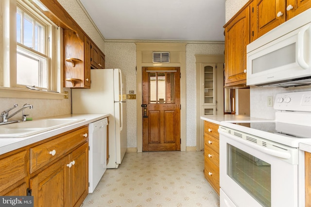 837 Broadway, Hanover, PA 17331 - kitchen featuring white appliances, wallpapered walls, a sink, light countertops, and brown cabinets