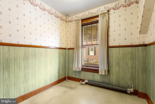 837 Broadway, Hanover, PA 17331 - unfurnished room with wallpapered walls, carpet flooring, wainscoting, radiator heating unit, and baseboards