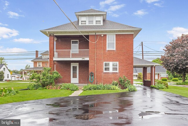 837 Broadway, Hanover, PA 17331 - rear view of house with a balcony, brick siding, asphalt driveway, a yard, and roof with shingles
