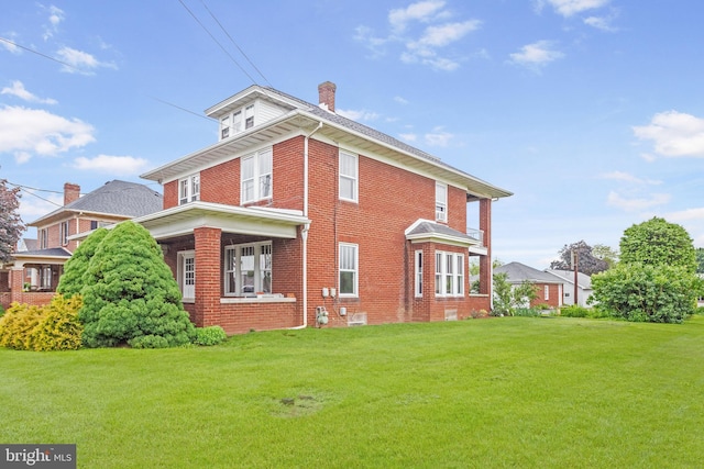 837 Broadway, Hanover, PA 17331 - view of property exterior with brick siding, a lawn, and a chimney