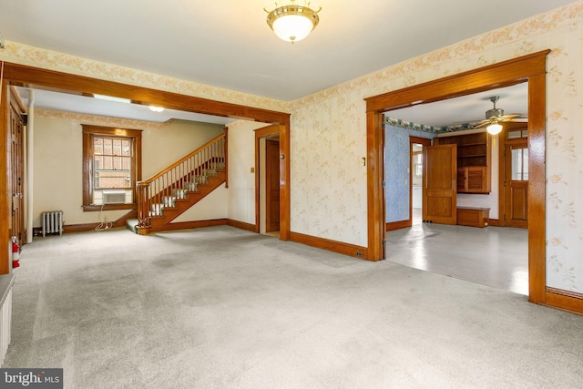 837 Broadway, Hanover, PA 17331 - unfurnished living room featuring radiator heating unit, wallpapered walls, carpet floors, baseboards, and stairs
