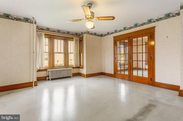 837 Broadway, Hanover, PA 17331 - empty room with radiator heating unit, french doors, wallpapered walls, concrete flooring, and a ceiling fan