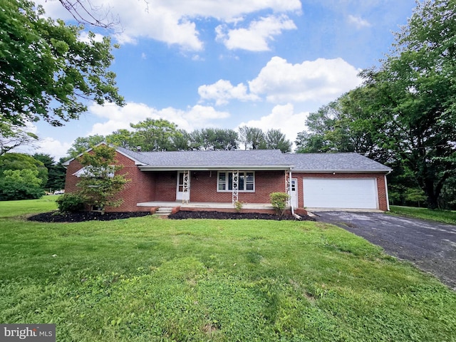 3390 Point Of Rocks Rd, Jefferson, MD 21755 - view of front of house with brick siding, asphalt driveway, a garage, a front yard, and covered porch