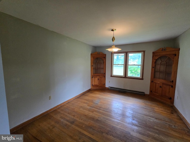 3390 Point Of Rocks Rd, Jefferson, MD 21755 - unfurnished dining area featuring baseboard heating, wood finished floors, and baseboards