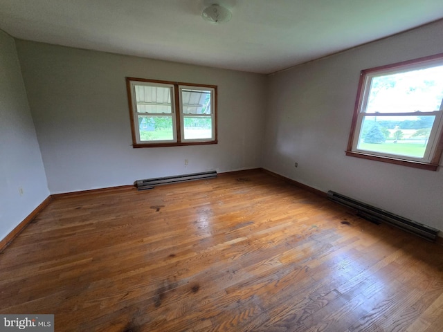 3390 Point Of Rocks Rd, Jefferson, MD 21755 - unfurnished room with baseboard heating, plenty of natural light, and wood finished floors