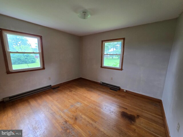 3390 Point Of Rocks Rd, Jefferson, MD 21755 - unfurnished room with wood finished floors, a baseboard radiator, baseboards, and baseboard heating