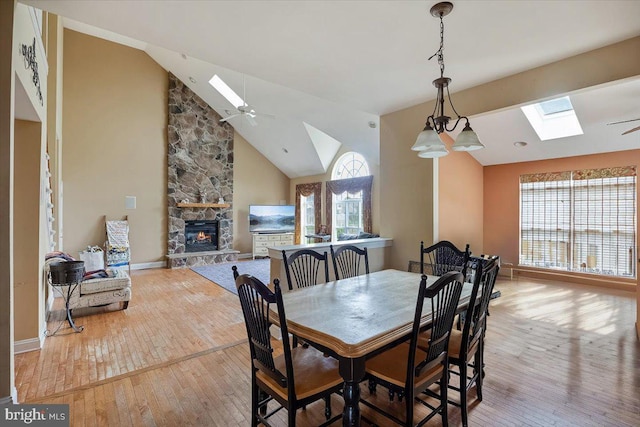 738 Farmhouse Rd, Mickleton, NJ 08056 - dining room with a skylight, a fireplace, wood-type flooring, ceiling fan, and high vaulted ceiling