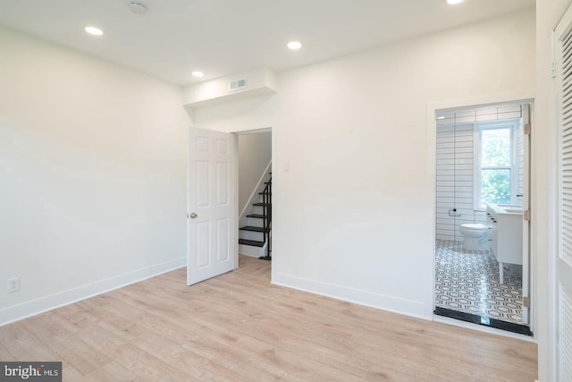 1606 Wharton St, Philadelphia, PA 19146 - empty room with wood finished floors, baseboards, recessed lighting, and stairway
