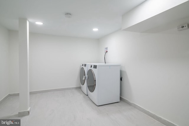 1606 Wharton St, Philadelphia, PA 19146 - laundry room with light marble finish floors, recessed lighting, baseboards, and washing machine and clothes dryer