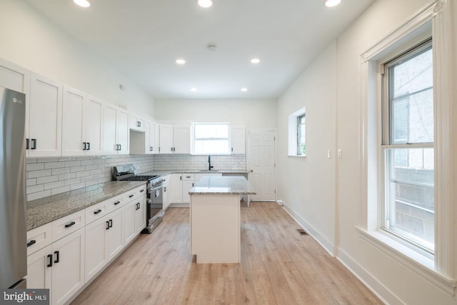 1606 Wharton St, Philadelphia, PA 19146 - kitchen with stainless steel appliances, a sink, light stone countertops, decorative backsplash, and recessed lighting