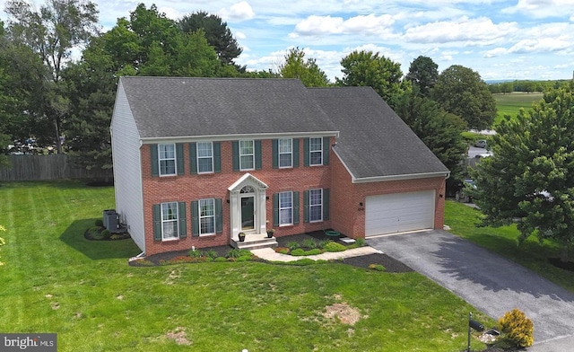 10526 Jasper Dr S, Greencastle, PA 17225 - colonial inspired home with asphalt driveway, a garage, cooling unit, and brick siding
