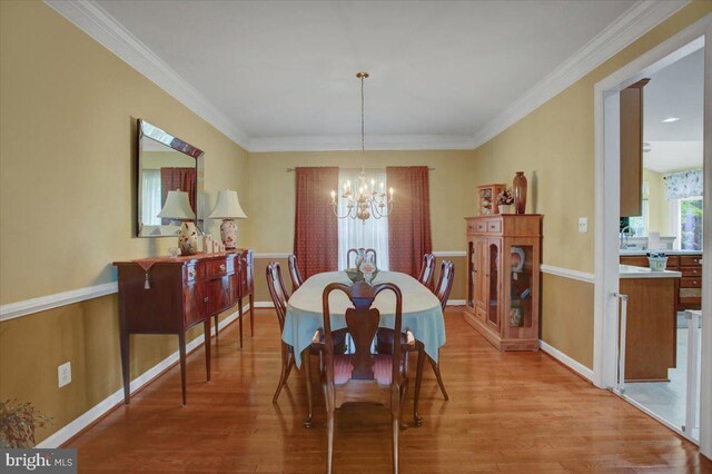 10526 Jasper Dr S, Greencastle, PA 17225 - dining space with light wood-style floors, a chandelier, and ornamental molding