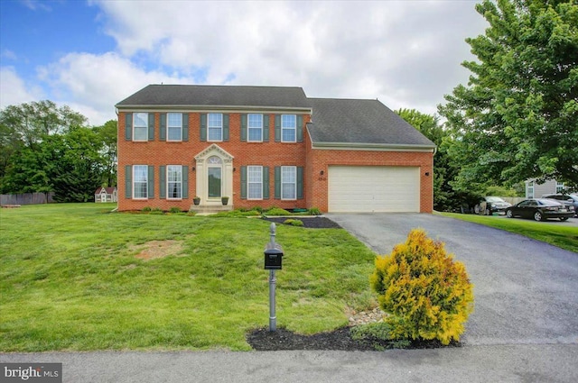 10526 Jasper Dr S, Greencastle, PA 17225 - colonial home featuring an attached garage, asphalt driveway, brick siding, and a front lawn