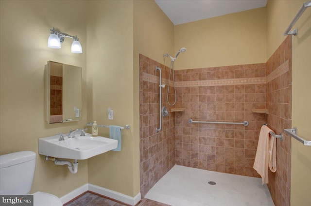 10526 Jasper Dr S, Greencastle, PA 17225 - full bathroom featuring toilet, tiled shower, a sink, tile patterned flooring, and baseboards