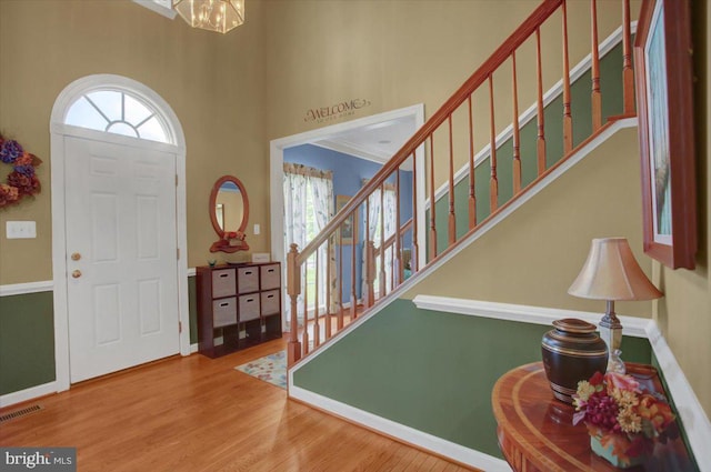 10526 Jasper Dr S, Greencastle, PA 17225 - foyer entrance with stairway, a chandelier, a high ceiling, wood finished floors, and baseboards