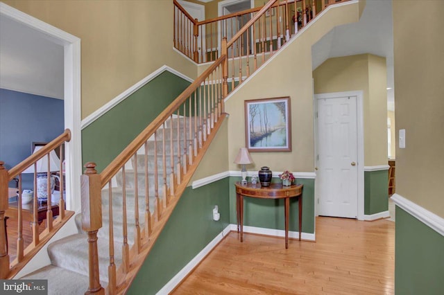 10526 Jasper Dr S, Greencastle, PA 17225 - staircase featuring wood finished floors, a towering ceiling, and baseboards