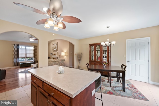 1009 Rosebud St, Reading, PA 19605 - kitchen with arched walkways, open floor plan, light countertops, ceiling fan, and light tile patterned floors