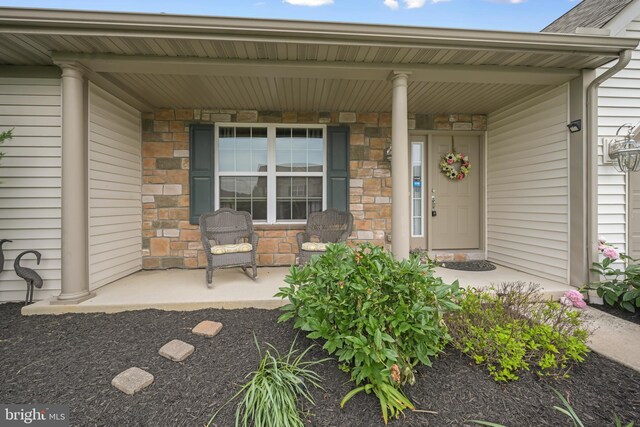 1009 Rosebud St, Reading, PA 19605 - view of exterior entry featuring a porch and stone siding
