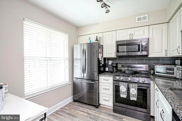 2305A Yarmouth Ln, Mount Laurel, NJ 08054 - kitchen with appliances with stainless steel finishes, white cabinetry, decorative backsplash, and dark stone countertops