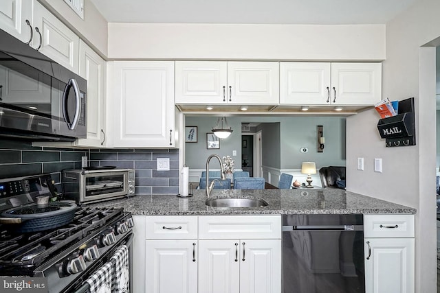 2305A Yarmouth Ln, Mount Laurel, NJ 08054 - kitchen featuring gas range, a sink, dishwashing machine, dark stone countertops, and backsplash