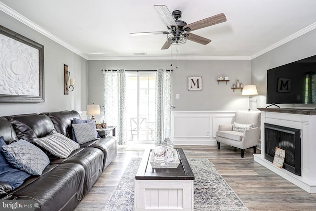 2305A Yarmouth Ln, Mount Laurel, NJ 08054 - living area featuring wood finished floors, ceiling fan, ornamental molding, a fireplace, and wainscoting