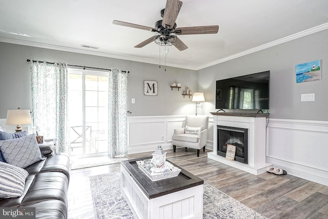 2305A Yarmouth Ln, Mount Laurel, NJ 08054 - living room featuring ceiling fan, ornamental molding, wood finished floors, a wainscoted wall, and a glass covered fireplace