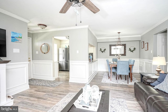 2305A Yarmouth Ln, Mount Laurel, NJ 08054 - living area featuring ceiling fan, light wood-style floors, crown molding, a wainscoted wall, and a decorative wall