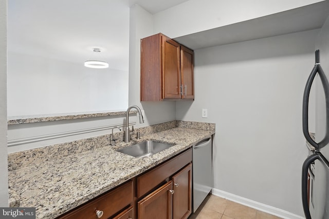1001 Randolph St N Unit 523, Arlington, VA 22201 - kitchen with a sink, stainless steel dishwasher, baseboards, light stone counters, and light tile patterned floors