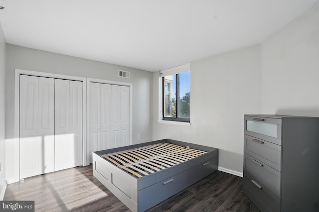 1001 Randolph St N Unit 523, Arlington, VA 22201 - bedroom featuring two closets, dark wood finished floors, and baseboards