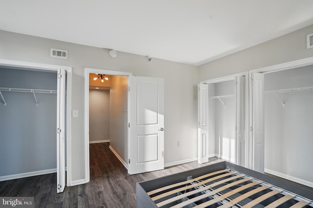 1001 Randolph St N Unit 523, Arlington, VA 22201 - unfurnished bedroom with two closets, wood finished floors, and baseboards