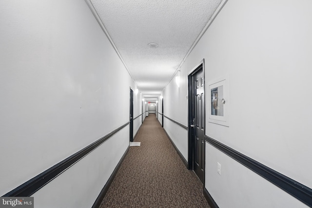 1001 Randolph St N Unit 523, Arlington, VA 22201 - corridor featuring a textured ceiling, dark carpet, and baseboards