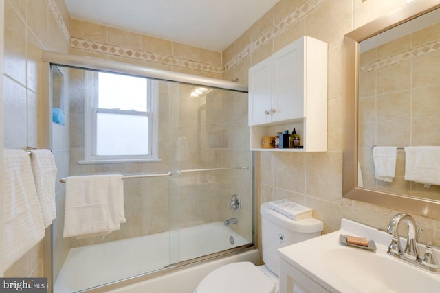 3312 Clay St, Silver Spring, MD 20902 - full bathroom featuring tile walls, combined bath / shower with glass door, toilet, and vanity