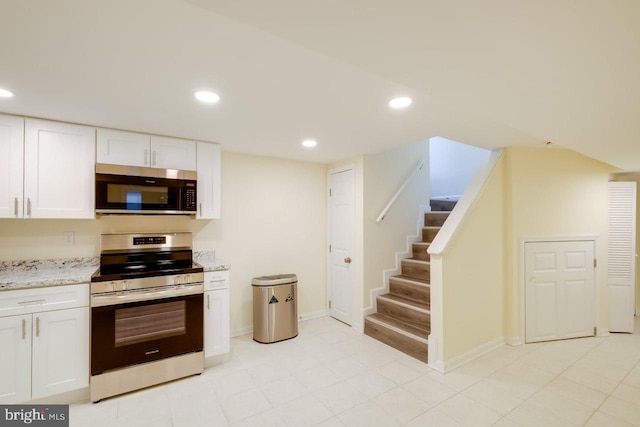 3312 Clay St, Silver Spring, MD 20902 - kitchen with appliances with stainless steel finishes, white cabinets, recessed lighting, light stone countertops, and baseboards