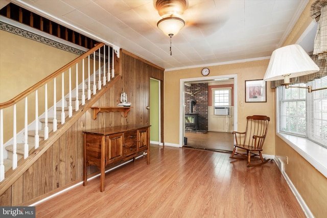 41 Collins Rd, Hamilton, NJ 08619 - living area with a wood stove, stairway, wood finished floors, wood walls, and ornamental molding