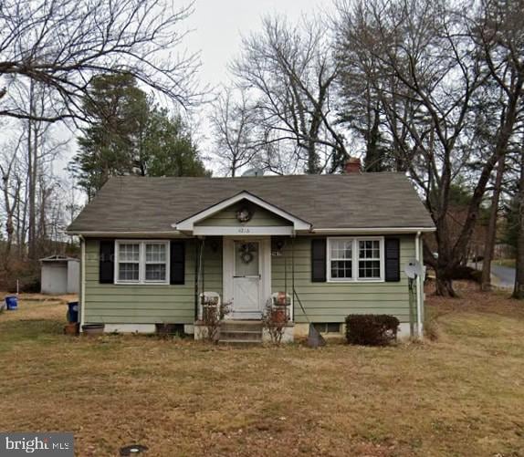 4216 Meyers Rd, Triangle, VA 22172 - bungalow-style house with a front lawn and a chimney
