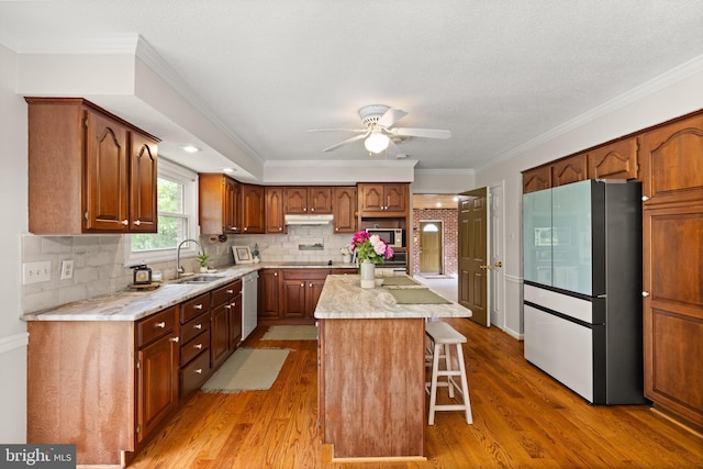 98 Magnificent Ln, Hedgesville, WV 25427 - kitchen with freestanding refrigerator, a sink, dishwasher, stainless steel microwave, and under cabinet range hood